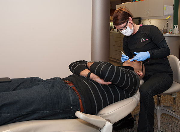 Our orthodontist assistant working on an actual patient in our Redmond, WA area office.